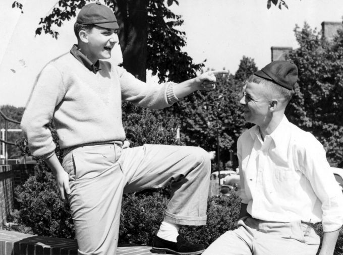 Black and white photo from 1906 with two male students wearing tiny baseball caps called "dinks" to show that they are underclassmen