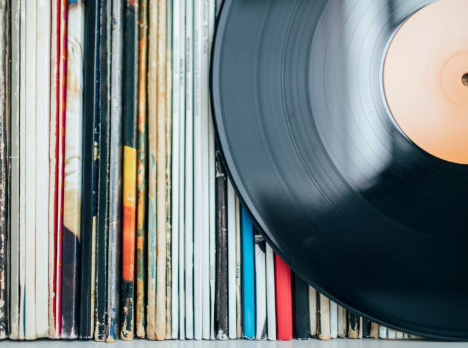 Bunch of vinyl records in sleeves stored vertically with one single record set in front